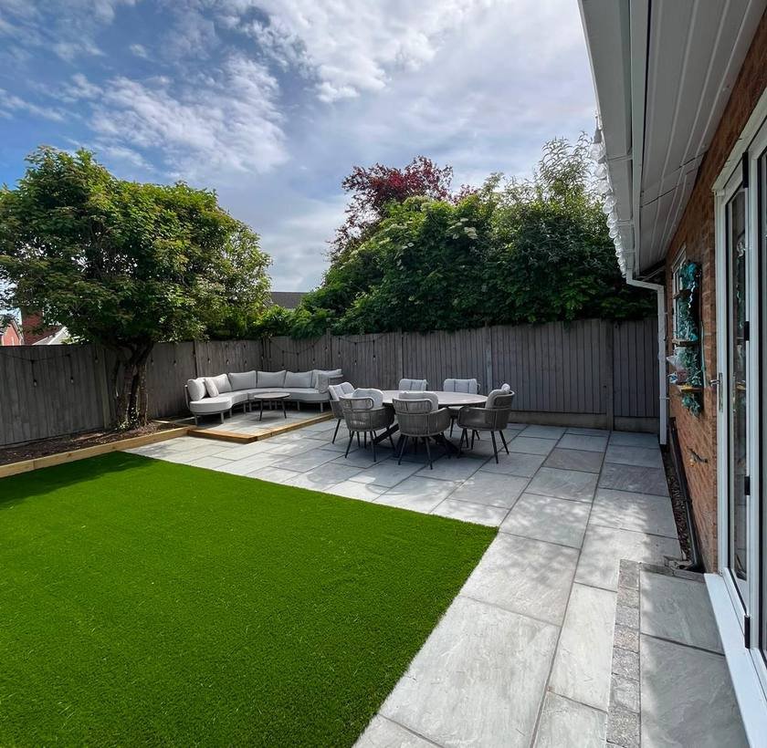 Artificial lawn with porcelain patio and garden seating